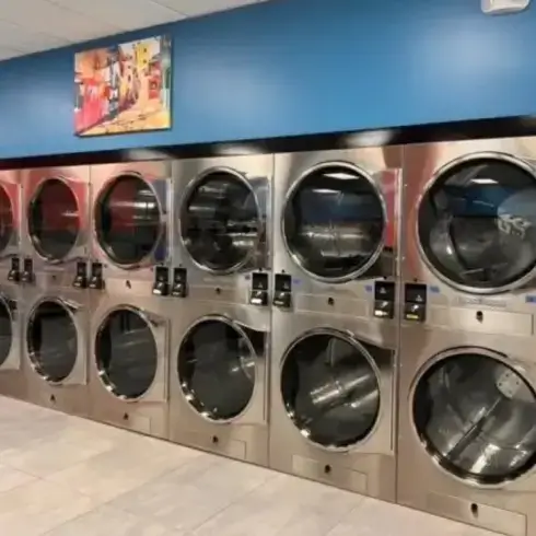Friendly staff assisting customers at Lux Laundromat in Dumfries